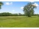 Scenic view of lush lawn, mature trees, and serene golf course, creating a peaceful and inviting outdoor space at 7559 Pipestone Dr, Indianapolis, IN 46217