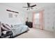 Cozy bedroom with star-themed wallpaper, a ceiling fan, a window with blinds, and a comfortable bed at 7559 Pipestone Dr, Indianapolis, IN 46217