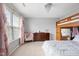 Bedroom featuring a loft bed with desk space below and a soft chair by the window with sheer curtains at 7559 Pipestone Dr, Indianapolis, IN 46217