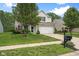 Charming two-story home with a well-manicured lawn and attached two-car garage at 7559 Pipestone Dr, Indianapolis, IN 46217