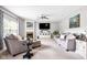 Bright living room with fireplace, ceiling fan, and comfortable gray furnishings at 7559 Pipestone Dr, Indianapolis, IN 46217