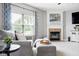 Inviting living area with a fireplace and large window dressed in elegant blue curtains at 7559 Pipestone Dr, Indianapolis, IN 46217