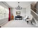 Elegant living room featuring a grand piano, modern chandelier, and staircase at 7559 Pipestone Dr, Indianapolis, IN 46217