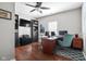 Spacious office featuring built-in shelving, ceiling fan, and rich wood floors, providing a professional workspace at 7559 Pipestone Dr, Indianapolis, IN 46217