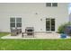 This cozy patio offers outdoor seating, a grill, and easy access to the backyard and house through a sliding glass door at 7559 Pipestone Dr, Indianapolis, IN 46217