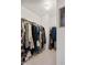 Bright walk-in closet with ample storage and clothing racks, a well-lit space for organization and convenience at 7559 Pipestone Dr, Indianapolis, IN 46217