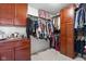 Spacious walk-in closet with built-in shelving, drawers, rods for hanging clothing and overhead storage at 7559 Pipestone Dr, Indianapolis, IN 46217