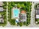 A stunning aerial view reveals a community pool, homes, green spaces and tree-lined streets, perfect for families at 7601 W Stonegate Dr, Zionsville, IN 46077