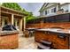 Backyard patio with a hot tub, grill, and outdoor kitchen area, perfect for entertaining at 7601 W Stonegate Dr, Zionsville, IN 46077