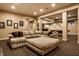 Open concept basement living room, view into basement bar and game room with pool table at 7601 W Stonegate Dr, Zionsville, IN 46077