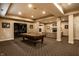 Finished basement includes a pool table, plush furniture, carpeted floor, and custom lighting at 7601 W Stonegate Dr, Zionsville, IN 46077