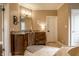 Well-lit bathroom featuring granite countertops, wood cabinets and tile flooring at 7601 W Stonegate Dr, Zionsville, IN 46077