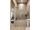 Modern bathroom showcases a shower-over-tub setup with sleek glass doors and tiled walls at 7601 W Stonegate Dr, Zionsville, IN 46077