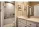 Bright bathroom featuring a vanity with marble countertop, a shower-over-tub, and framed artwork at 7601 W Stonegate Dr, Zionsville, IN 46077