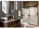 Elegant bathroom boasts a wood vanity with marble countertop and a glass-enclosed shower at 7601 W Stonegate Dr, Zionsville, IN 46077