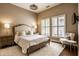 Elegant bedroom features a neutral color palette, plush carpet, and shuttered windows for natural light at 7601 W Stonegate Dr, Zionsville, IN 46077