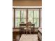 Bright sitting area with plantation shutters, a desk and chair in a well-lit bedroom at 7601 W Stonegate Dr, Zionsville, IN 46077