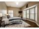 Bedroom featuring neutral tones, modern furnishings, plantation shutters, and a plush rug at 7601 W Stonegate Dr, Zionsville, IN 46077