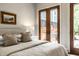 Bedroom featuring neutral decor, private balcony and hardwood floors at 7601 W Stonegate Dr, Zionsville, IN 46077