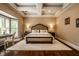 Comfortable bedroom features a tray ceiling, large windows, and a cozy sitting area at 7601 W Stonegate Dr, Zionsville, IN 46077