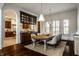 Dining room showcasing dark wood cabinetry, hardwood floors, and modern pendant lighting at 7601 W Stonegate Dr, Zionsville, IN 46077