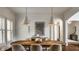 Well-lit dining area showcases modern pendant lighting and elegant decor at 7601 W Stonegate Dr, Zionsville, IN 46077
