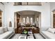Open-concept dining room with hardwood floors, arched doorway, and modern lighting at 7601 W Stonegate Dr, Zionsville, IN 46077
