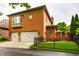 Brick home featuring a three-car garage, bay window, and mature landscaping at 7601 W Stonegate Dr, Zionsville, IN 46077