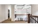 Open hallway features coffered ceiling, wooden handrail, and access to multiple rooms at 7601 W Stonegate Dr, Zionsville, IN 46077