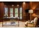 Stately home office features custom built-ins, wood paneled walls and plush carpet at 7601 W Stonegate Dr, Zionsville, IN 46077