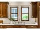 Gourmet kitchen featuring wood cabinets, undermount sink and white marble countertop at 7601 W Stonegate Dr, Zionsville, IN 46077