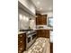 Gourmet kitchen featuring wood cabinets, stainless steel appliances and marble countertops at 7601 W Stonegate Dr, Zionsville, IN 46077
