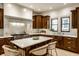 Bright kitchen features a center island with counter seating, stainless appliances, and granite counters at 7601 W Stonegate Dr, Zionsville, IN 46077