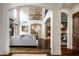 Spacious living room with high ceilings, hardwood floors, a fireplace, and an open layout with elegant archways at 7601 W Stonegate Dr, Zionsville, IN 46077