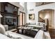 Elegant living room with a fireplace, high ceilings, hardwood floors, and tasteful furnishings for a sophisticated space at 7601 W Stonegate Dr, Zionsville, IN 46077