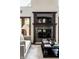 Living room features a fireplace, hardwood floors, and natural light for a warm, inviting atmosphere with french doors at 7601 W Stonegate Dr, Zionsville, IN 46077
