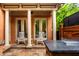 Covered patio featuring rocking chairs, stone columns, and a granite serving area at 7601 W Stonegate Dr, Zionsville, IN 46077