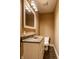Powder room with white vanity, dark countertop, decorative mirror, and tiled floors at 7601 W Stonegate Dr, Zionsville, IN 46077