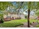 Private backyard with green grass, a mature tree, and multiple decks with a serene, natural ambiance at 764 Bloor Woods Ct, Zionsville, IN 46077