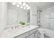 Bathroom featuring double sink vanity with quartz countertops and tiled shower at 764 Bloor Woods Ct, Zionsville, IN 46077