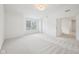 Bedroom with neutral carpet, window, and open doorway at 764 Bloor Woods Ct, Zionsville, IN 46077