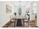 Formally staged dining room with artwork and dining table at 764 Bloor Woods Ct, Zionsville, IN 46077