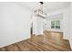 Open-concept dining area with modern light fixture and hardwood floors at 764 Bloor Woods Ct, Zionsville, IN 46077
