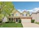 Charming two-story home featuring a well-manicured lawn, brick accents, and an attached two-car garage at 764 Bloor Woods Ct, Zionsville, IN 46077