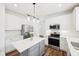 Stylish kitchen boasting white cabinets, stainless steel appliances, a quartz island, and modern lighting at 764 Bloor Woods Ct, Zionsville, IN 46077