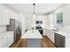 Bright kitchen with white cabinets, stainless steel appliances, a central island, and subway tile backsplash at 764 Bloor Woods Ct, Zionsville, IN 46077