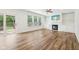 Bright living room with a fireplace, built-in shelves, hardwood floors, and a sliding glass door to the patio at 764 Bloor Woods Ct, Zionsville, IN 46077