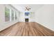 Bright, open living room featuring a fireplace, built-in shelves, hardwood floors, and large windows at 764 Bloor Woods Ct, Zionsville, IN 46077