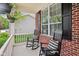 Inviting front porch with comfortable rocking chairs and striped pillows showcasing the home's exterior details at 764 Bloor Woods Ct, Zionsville, IN 46077