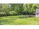 Expansive backyard with lush green grass and a wooden deck perfect for outdoor entertaining at 8100 N Meridian St, Indianapolis, IN 46260